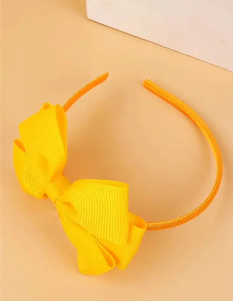 Dětská vlasová čelenka s mašličkou ve žluté barvě 